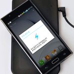 Smartphone on a wireless charging pad (Qi standard)