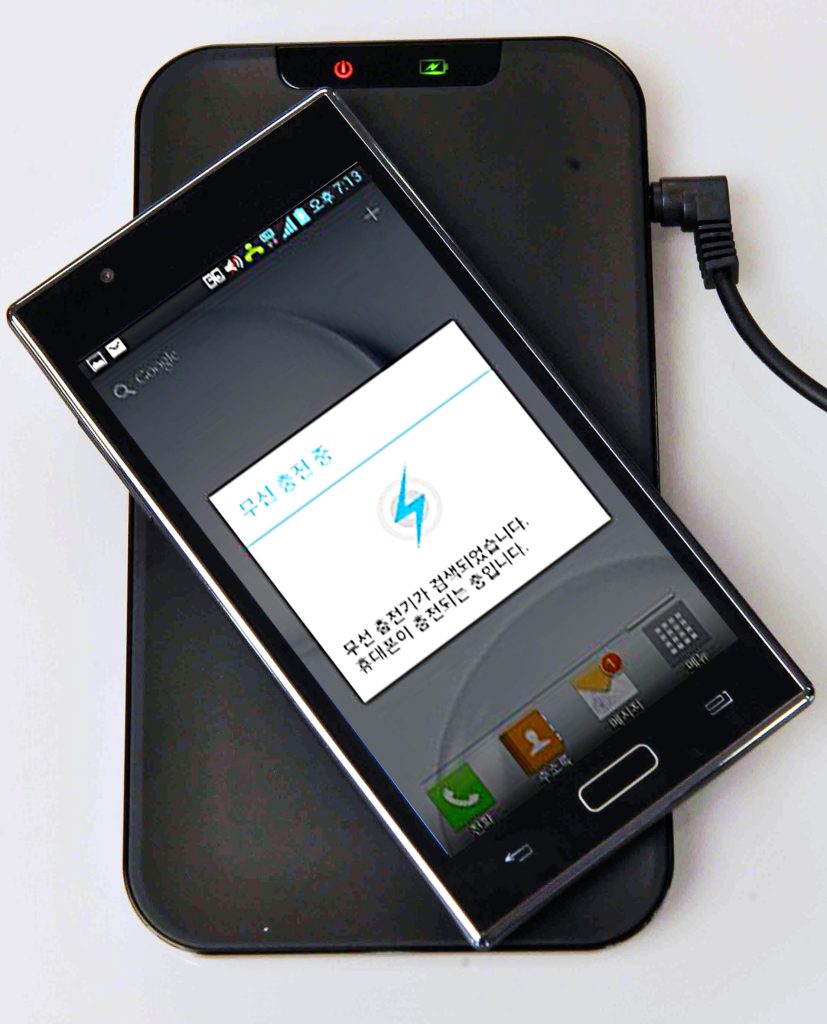 Smartphone on a wireless charging pad (Qi standard)