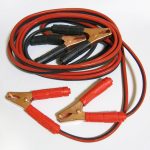 Booster cables coiled on the ground