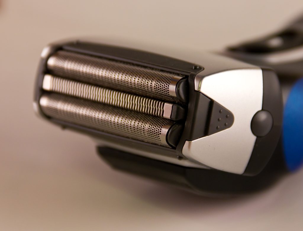 Electric shaver on white background