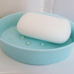 Bar soap in a plastic travel soap dish