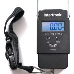 Portable luggage weighing scale holding a bag